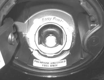11. Place the Premium Unleaded Fuel Only Decal (13109A095) inside the fuel door, below the fuel filler neck. 12.