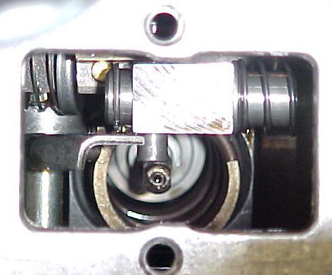 Place the end of the screwdriver on top of the governor stud and slide the part down the screwdriver and into position.