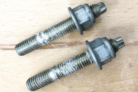 Use a 18mm wrench and a 8mm socket wrench to detach the nuts from the studs.