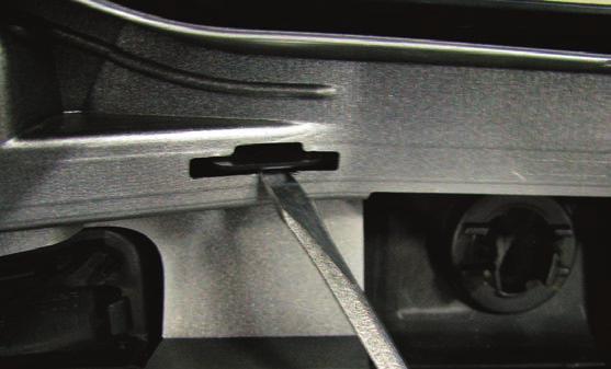that secure the lower moulding to the bumper while pushing out on