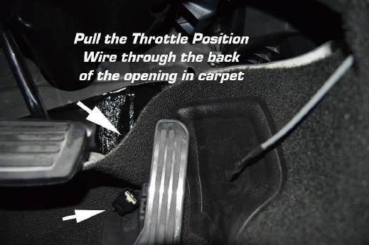 Step 4: Pull the OE TPS connector through the opening in the carpet toward the floorboard.