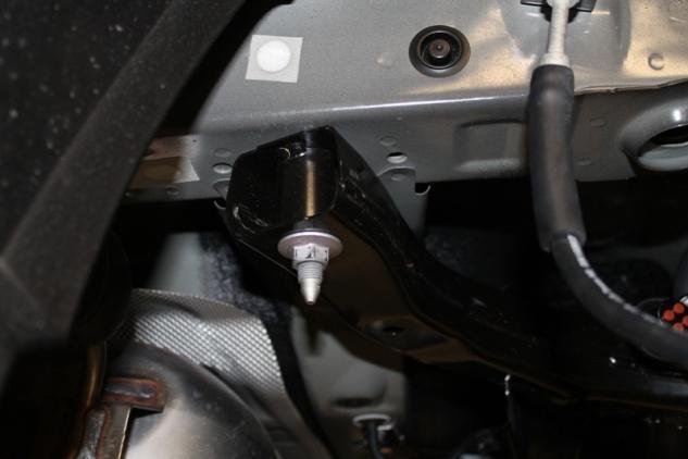 Using a 17mm socket and extension, loosen the 2 nuts on the driver s side securing