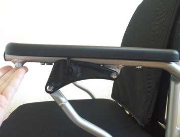 Flip armrest up by pushing it in the direction of the red