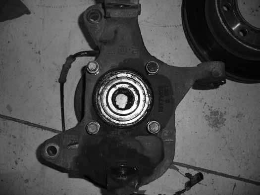 Take care not to over-tighten 3/8" hardware at the transmission crossmember. 52. Remove the hub bearing and brake dust shield from the factory steering knuckles Figure 30.