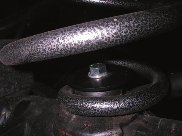 Use a little grease on both pieces to help them pop into place. 18. Install the lower bump stop onto the axle pad with the 5/16 x 1.