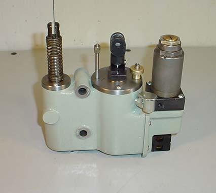 Figure 1 Dashpot with Solenoid Bypass (solenoid bypass assembly shown at right) The problem that occurs when a solenoid operated dashpot by-pass needle valve assembly is improperly adjusted is the