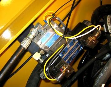 5. Install Wire Harness and Momentary On/Off/On toggle switch in empty bay in the cab of loader and install wires to valve. (Cutting maybe necessary if no open bays are available) 6.