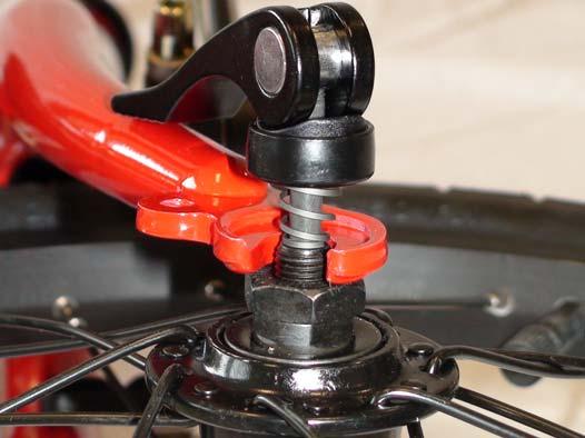 2) Using the thin black quick release axle, remove the thumb nut from