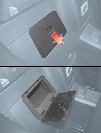 Note: When using the rear console cup holders, remove any cups before opening the seat side compartment.