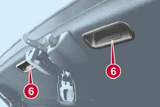 5. Remove the striker from the anchor. 6. Standing outside of the vehicle, hold the convertible top along the front edge and pull it toward the rear of the vehicle.