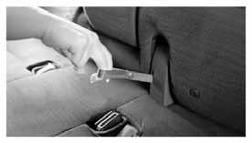 Before folding down the seatback, tuck the seat belt buckles into the seat cushion pockets. Fold the seatback down by pulling the adjusting strap.