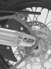 Push the rear wheel as far to the front as possible, take the chain off of the rear sprocket and lay it on the rear sprocket guard. Carefully lift the rear wheel out of the swing arm.