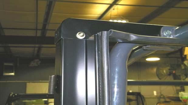 ... Position the top mount in place by lifting up on the roll bar tubes and sandwiching it between the tubes and the front part of the roll bar, with the rubber seal facing the rear.