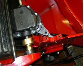 The rear transmission assembly is held into the machine by two screws and two arched