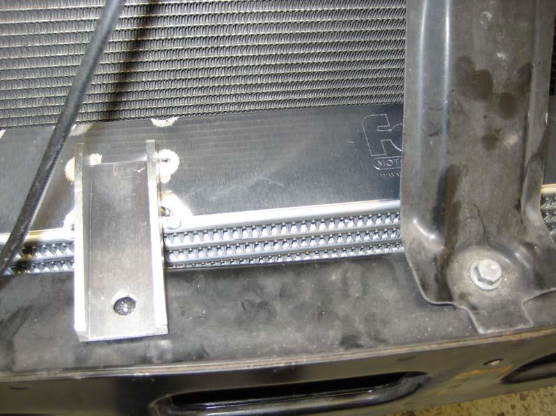 13. Offer up the intercooler to the bumper bar. The mounting holes on the brackets are 295mm apart. Take the 10mm bolt on the top of the bar as the middle, each of your holes needs to be 147.