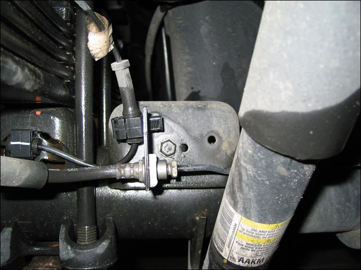 9 Remove the M8 hex cap screws (Figure 2C) retaining the brake line to the jounce bumper stops. Discard the screws.