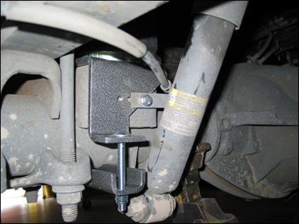 26 Using the M8 cap screws, attach the emergency brake cable bracket to the lower bracket of the air bag assembly on the passenger side of the vehicle. Torque this screw to 16 N*m (12 Lbf-ft).