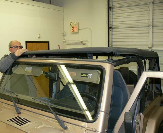 to stretch. Close the header latches to secure the front of the top to the windshield.