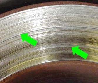 Brake Rotor Inspection Grooves deep enough that the rotor thickness, when measured in the grooves, is thinner than