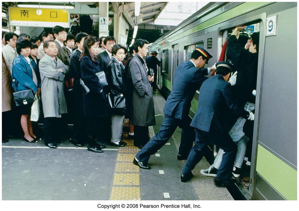 TOKYO SUBWAY Subway pushers help push as many people as possible into subway cars