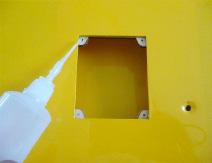 2) Place the servo between the mounting blocks and space it from the hatch.