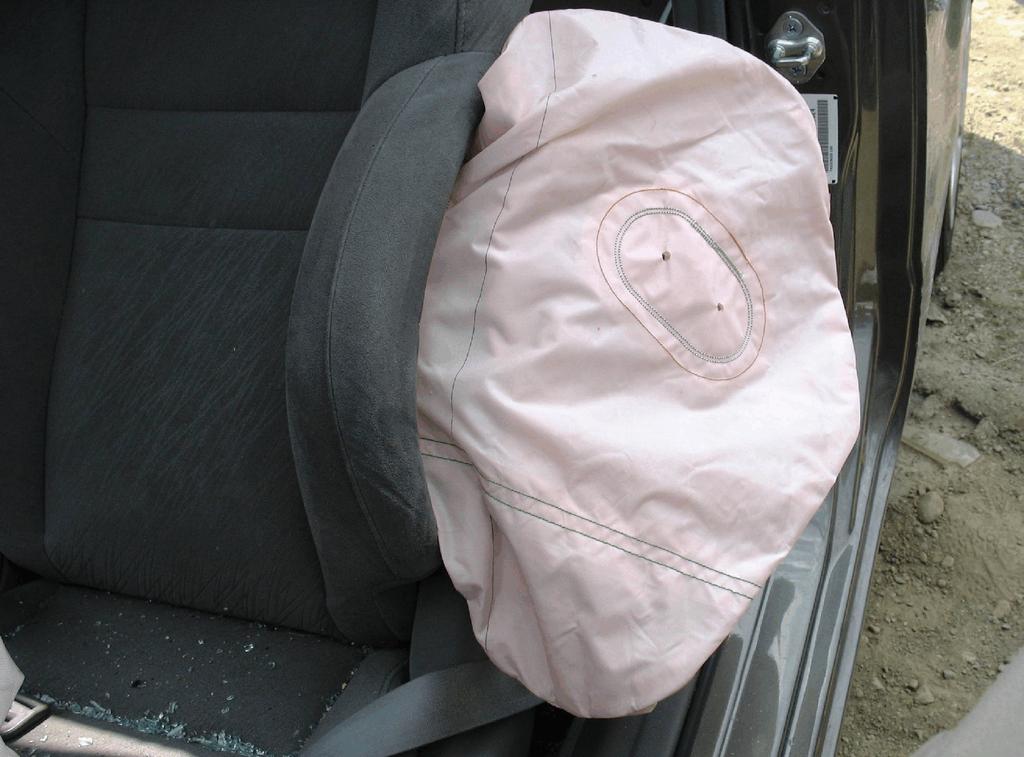 cover flaps (Figure 7). It was configured with two circular vent ports and two internal tethers. The air bag was circular in shape and measured 47 cm (18.5 in) in diameter in its deflated state.