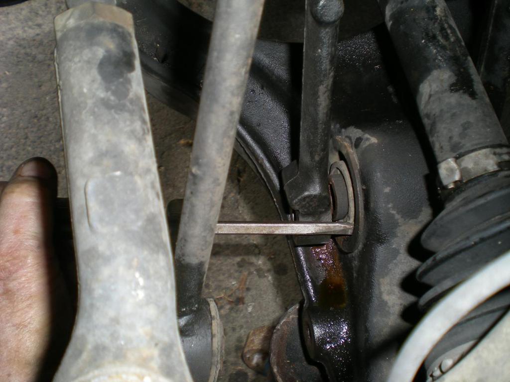 Push the fork away from you as far as it will go but make sure it is resting on the little flang on the lower edge of the control arm. The flange is smaller on the other side.