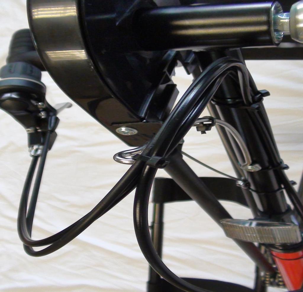 1) Use a zip tie to attach the three cables to the retainer; this will prevent the cable from wrapping around the hand grips during pedaling.