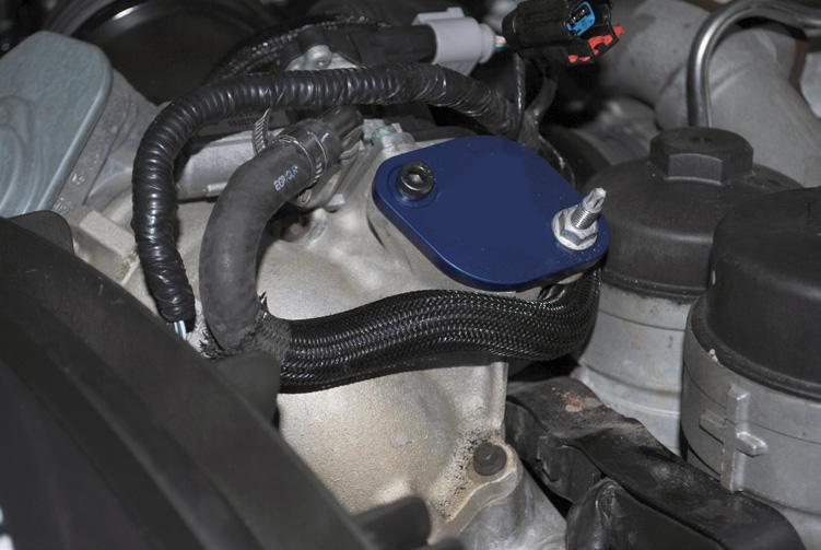 Step 35: Re-connect the upper radiator hose and make sure the metal clips are securely in place.