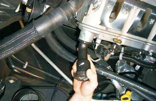 41. Remove the long oil filler neck from the valve cover by rotating it