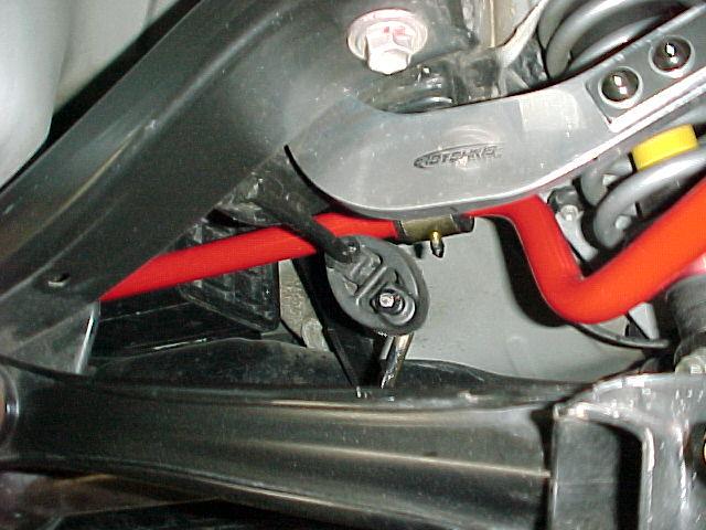 2) Unbolt the exhaust flange by loosening and removing the two retaining nuts.