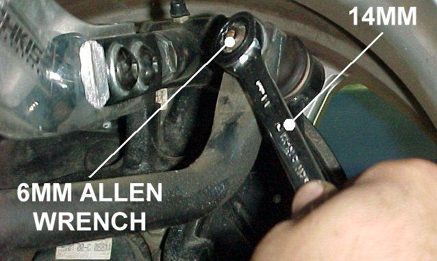 3) Use a 14mm wrench and a 6mm Allen wrench to loosen and remove the