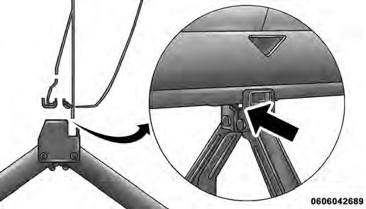 Loosen (but do not remove) the wheel lug bolts with the wrench handle by turning them to the left