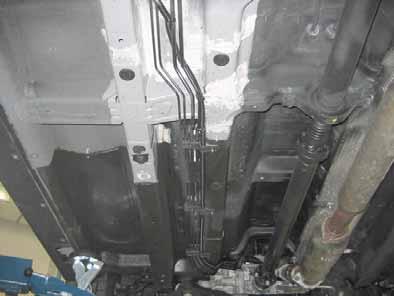Route fuel line and wiring harness of metering pump into corrugated tube in underbody to the