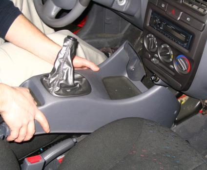 6. Lift up on the rear portion of the front half of the console to remove it from the vehicle and place in a safe location for re-installation.