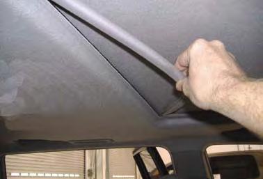 5. By hand pull moon roof trim ring away from headliner.