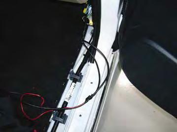behind dash. Attach ring terminal from black wire of 12 harness E2 and re-install bolt.