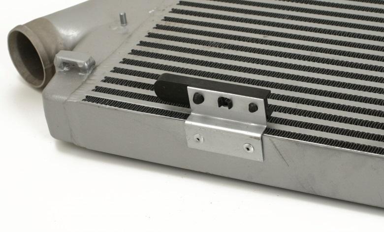 Remove the lower AC condenser plastic brackets from the OEM intercooler and