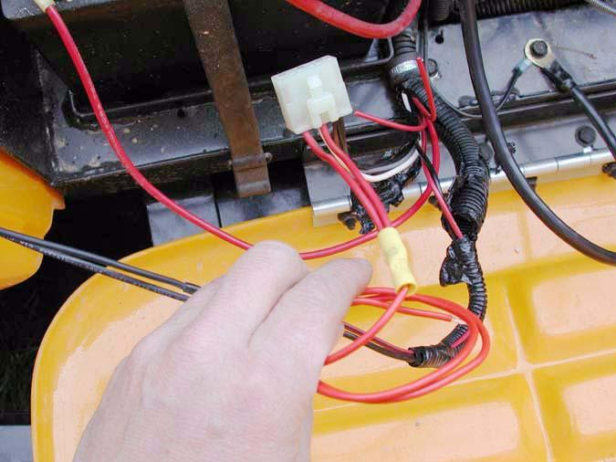 1.10. Fold the stripped end back on itself, and crimp it securely into the other end of the yellow butt connector. See Figure 1.10. Harness connector 2 Original red wires Yellow butt connector 1.14.