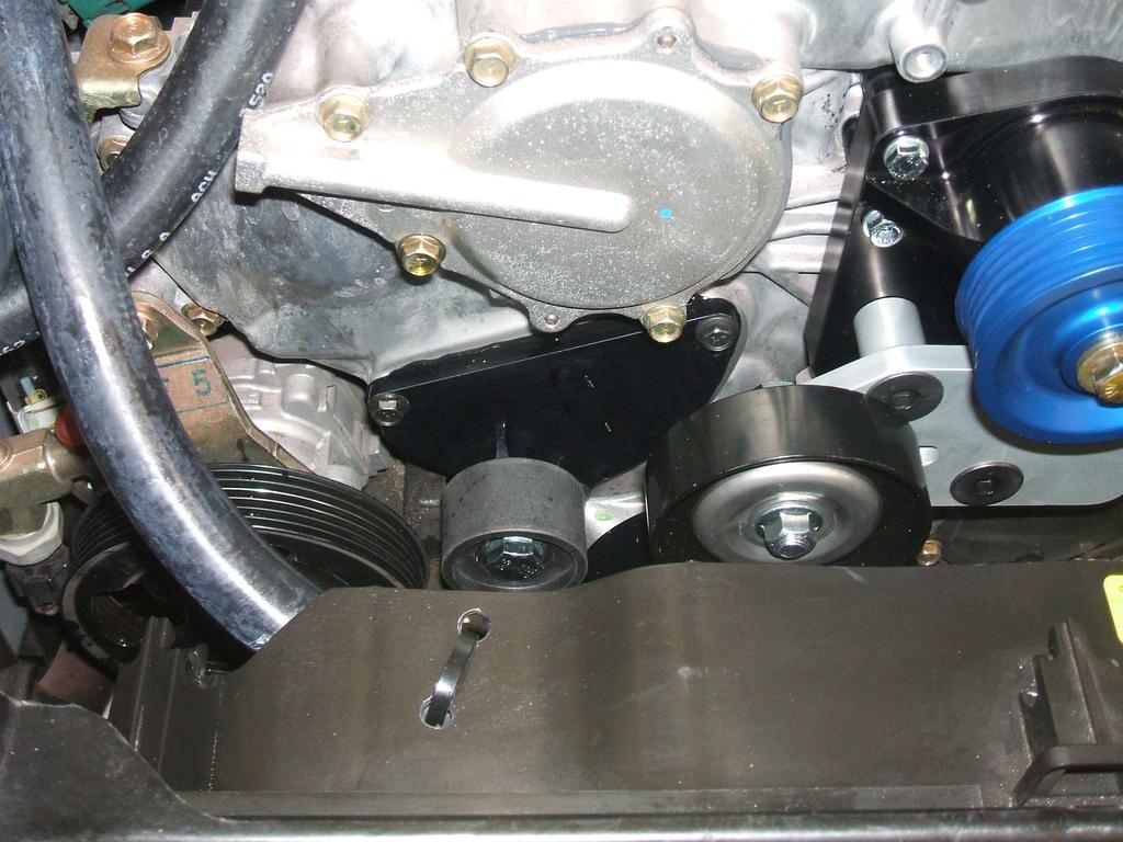 Using the supplied 40 hose and 90 fittings, route the 40 hose between the injectors and the left cylinder head.