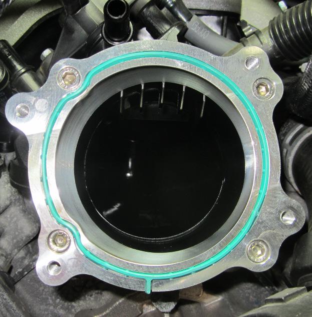 Install throttle body adapter. Torque to 7 ft. lbs.