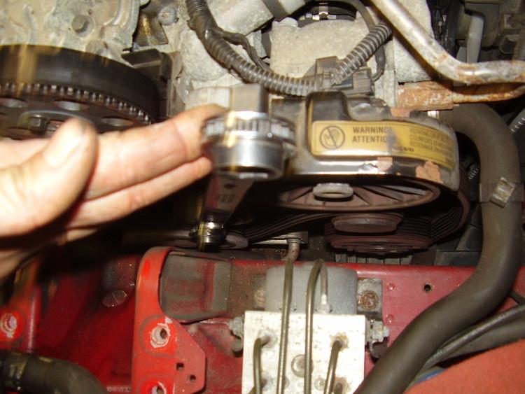 3 of 7 8/7/2012 9:31 PM Now use a long 14mm wrench and release the serpentine belt tensioner, remove the belt.
