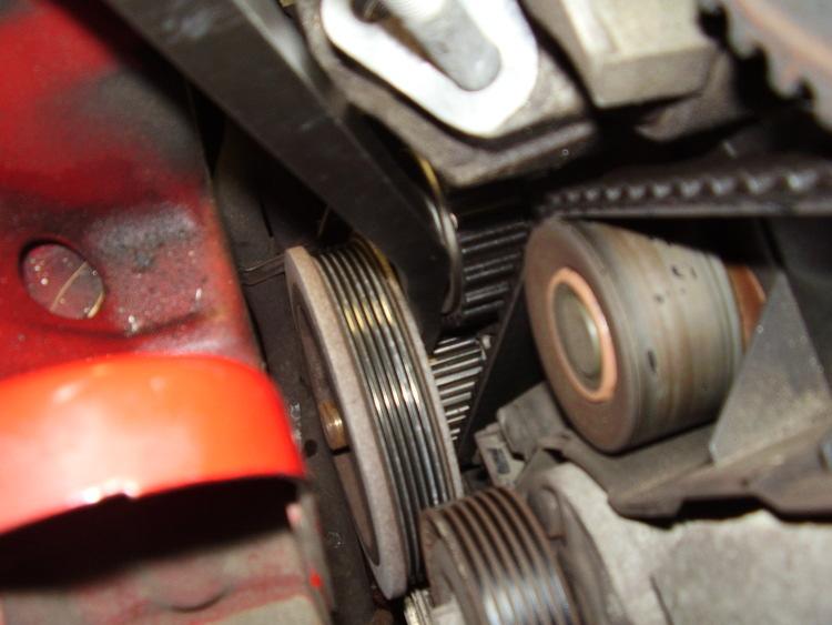 Align the cam gears straight up with the 2 cutouts on the underside of the forward spark plug cover. With it all in time go back down and remove the 4-10mm bolts and the 30mm crank pulley nut.