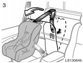 LS13064b 3. Pull the seatback release lever and swing the seatback forward slightly. Route the top strap through the routing device as shown in the illustration.