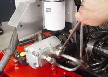 Install the two hydraulic lines to the hydraulic fittings located on the left side of the