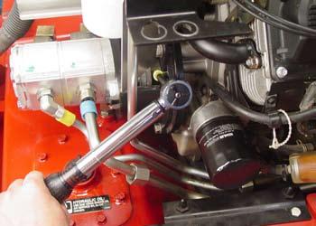Install the two hydraulic suction lines located on the right side of the hydraulic pump.