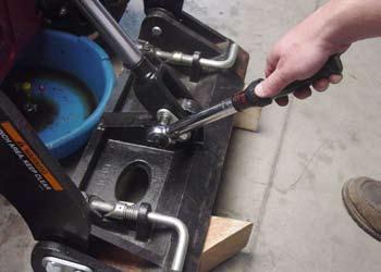 20. Remove the protective caps from the hydraulic fittings and pull on the ram of hydraulic cylinder to extend it.
