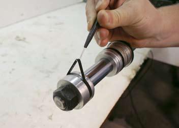 INSPECT TUBE ASSEMBLY: Visually inspect the inside bore for scratches and pits. There should be no scratches or pits deep enough to catch the fingernail.