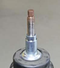 Once the spring is compressed, remove the 21mm nut on the top of the strut.