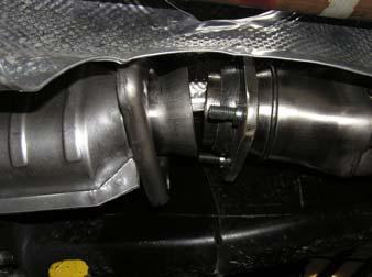 Engage the ball socket of the converter with the donut gasket on the right side header collector. (See the arrow in the picture below showing the converter orientation in the tunnel.